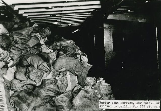 "Harbor boat service, New York. Mail stacked to ceiling for 135 ft."